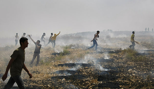24 hours: Asira al-Qiblyia, West Bank: Palestinian villagers try to put out fires