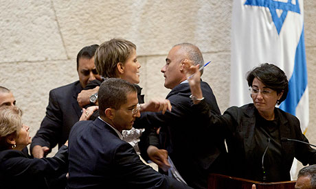 Haneen Zuabi attempts to speak at Israeli Knesset as Anastassia Michaeli is escorted off the podium