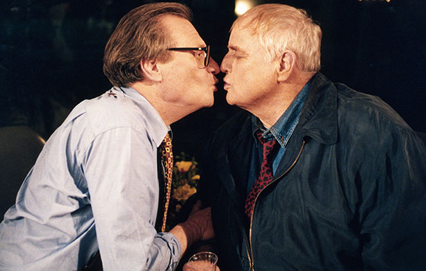 Larry King retires: 1994: Marlon Brando plants kiss on talk show host Larry King