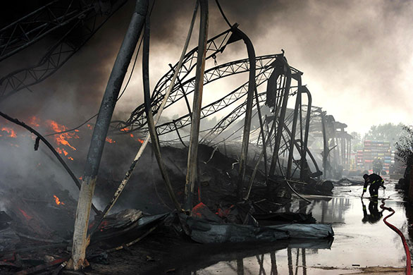 24 hours in pictures: Beijing, China: Firefighters try to extinguish a blaze  