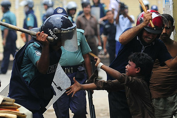 24 hours in pictures: Bangladeshi policemen hit a child 