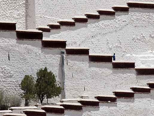 24 hours in pictures: A tourist walks ups the main steps of the Potala Palace in Lhasa, Tibet