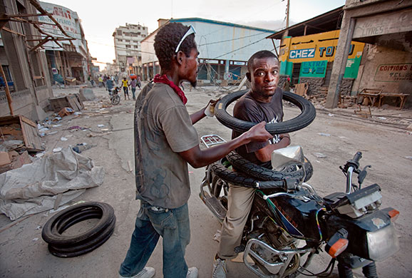 Press Photographer's Year: Young men trade tyres recently scavenged in downtown Port-Au-Prince
