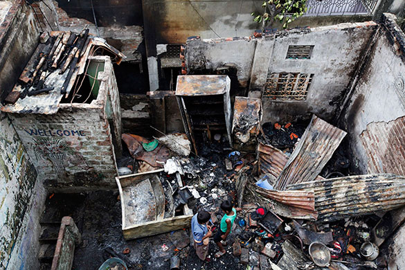 Dhaka fire: Children look at the damage at a two-storey building after a fire in Dhaka