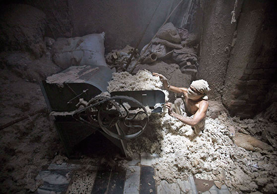 24 Hours: A man works inside a cotton factory in Mumbai