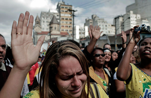 24 Hours: A woman cries while praying during the annual 'March for Jesus' parade