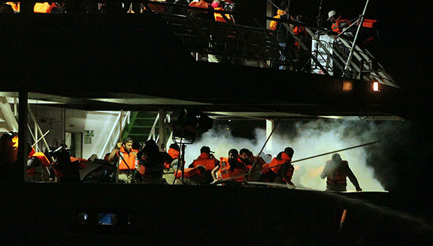 Mavi Marmara interception: Passengers run as they are surrounded by smoke from tear gas 