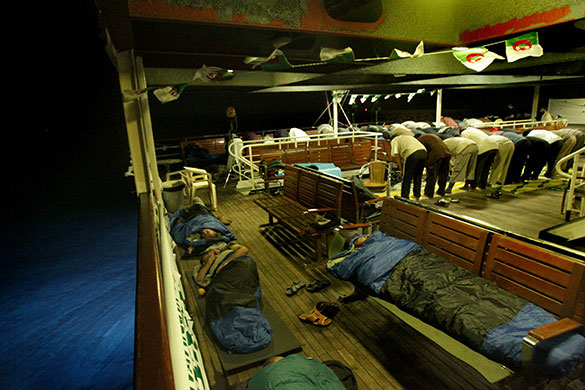 Mavi Marmara interception: Activists sleep and pray on the Turkish passenger ship Mavi Marmara