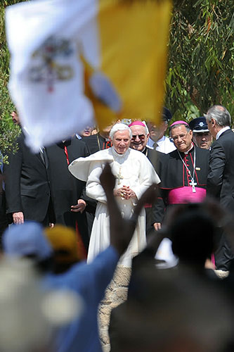 Pope in Cyprus: Pope Benedict XVI is greeted by people waving Vatican flags