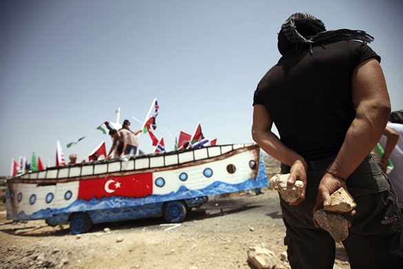 24 hours in pics: A Palestinian man holds stones