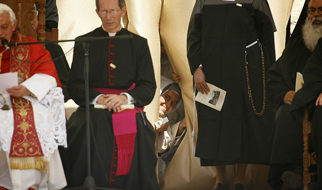 24 hours in pics: A nun peers from behind the curtain of t