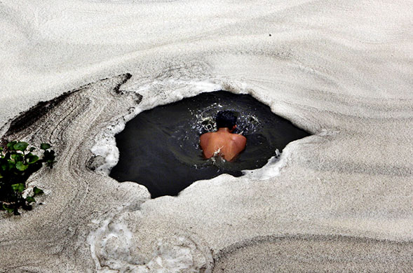 24 hours in pics: Indian boy takes a dip in the River Yamuna