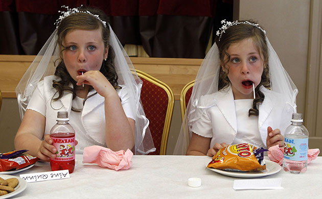24 hours: Twins after taking their First Holy Communion in Northern Ireland 