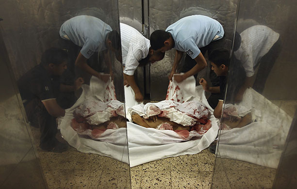24 hours in pictures: The body of one of four militants killed by an Israeli naval patrol