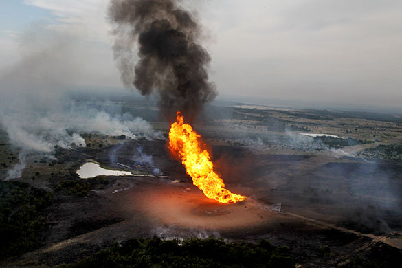 24 hours in pictures: Cleburne, US: Flames shoot into the air after a natural gas line explosion