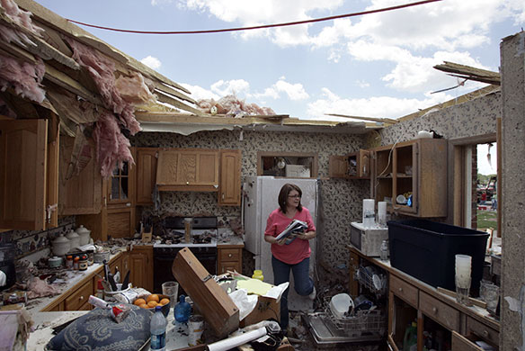 24 hours in pictures: Millbury, US: Darlene Sheehy collects items from her home after a tornado