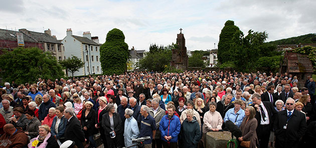 Cumbria memorial services: People gather on the village green in Whitehaven