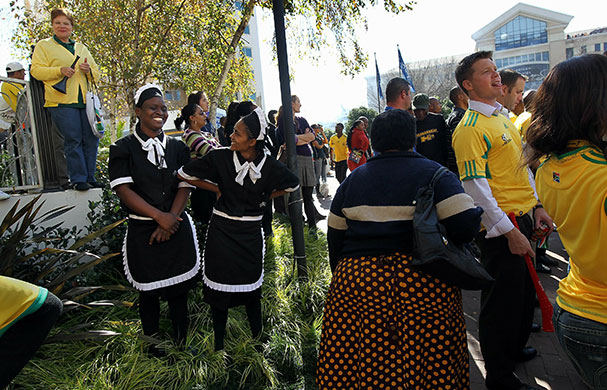World Cup parade: Hotel workers stand amognst a throng of fans awaiting their national team