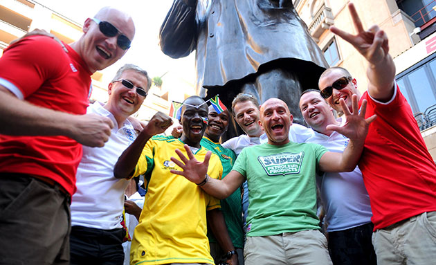 Johannesburg parade: A group of England supporters pose beside a statue of Nelson Mandela