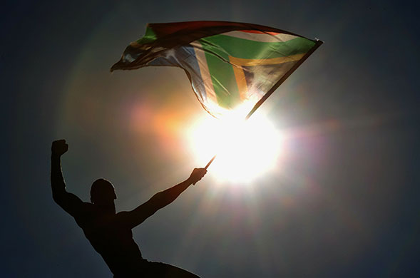 Johannesburg parade: A fan waves a South African flag during the parade