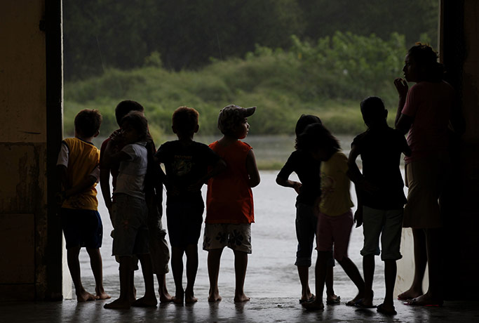 Hurricane Alex: Children evacuees look out from a convention centre being used as a shelter