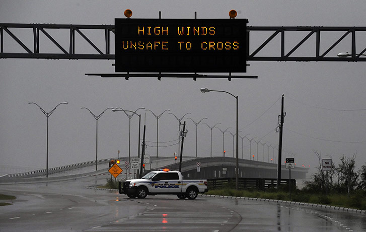 Hurricane Alex: A police officer blocks the road onto the bridge off South Padre Island