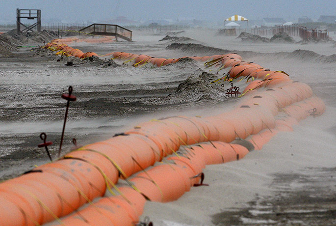 Hurricane Alex: Sand blows across a tiger dam on a beach 