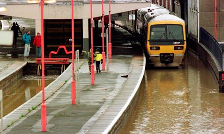 Train standing at waterlogged station
