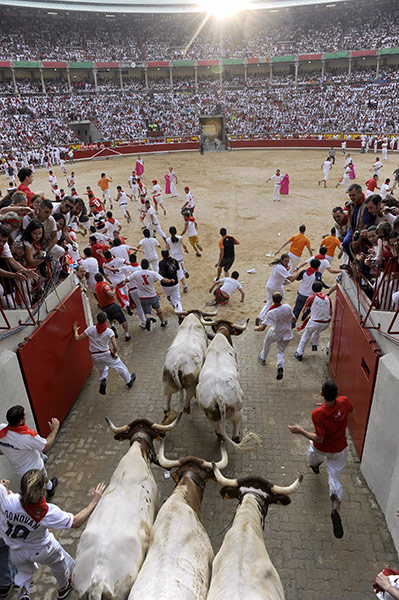 24 Hours: Participants run with Miuras fighting bulls at San Fermin Festival, Spain 