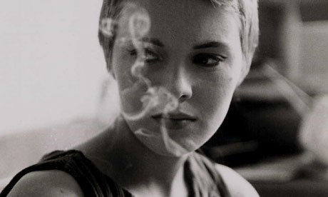 Jean Seberg looking sultry behind a plume of Chesterfield cigarette smoke on