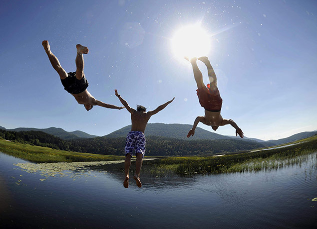 24 hours in pictures: Slovenia: Boys jump into lake Cerknica
