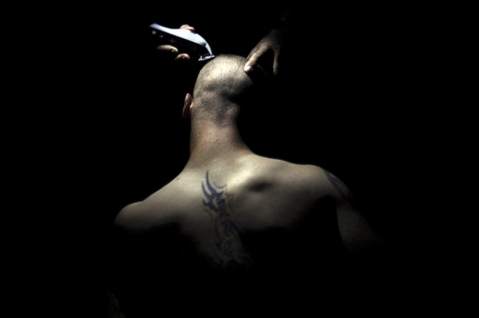 24 hours in pictures: Arghandab Valley, Afghanistan: A US soldier has his head shaved