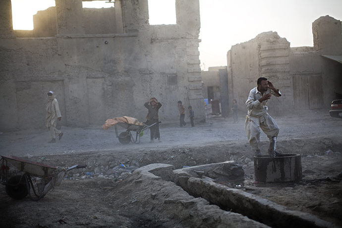 24 hours in pictures: Kabul, Afghanistan: People cover their faces during a dust storm