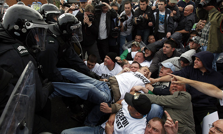 Belfast riots: Police dressed in riot gear remove Nationalists blocking the Crumlin Road