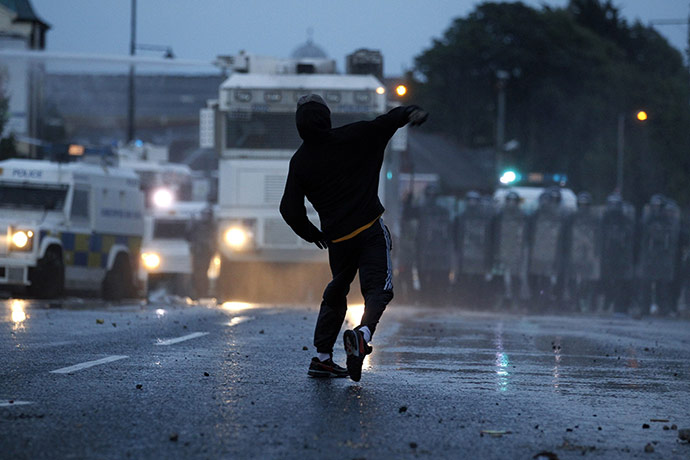 Belfast riots: A Nationalist throws a missile at police in the Ardoyne area, north Belfast