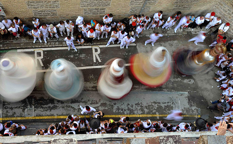 24 hours pictures: Figures dance through the streets during San Fermin festival in Pamplona