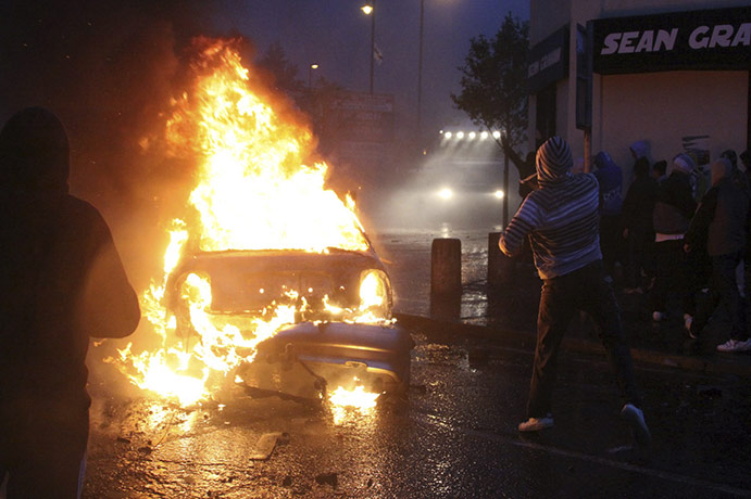 Belfast riots: Irish nationalist rioters burn a hijacked car in the Ardoyne 