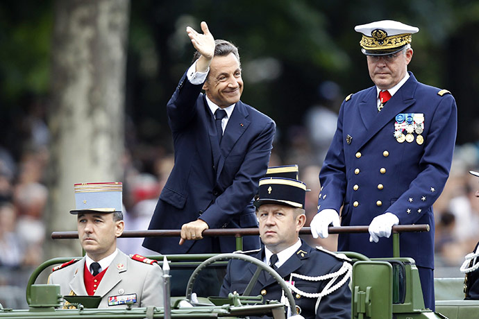Bastille day: France's President Nicolas Sarkozy (C) waves to the public