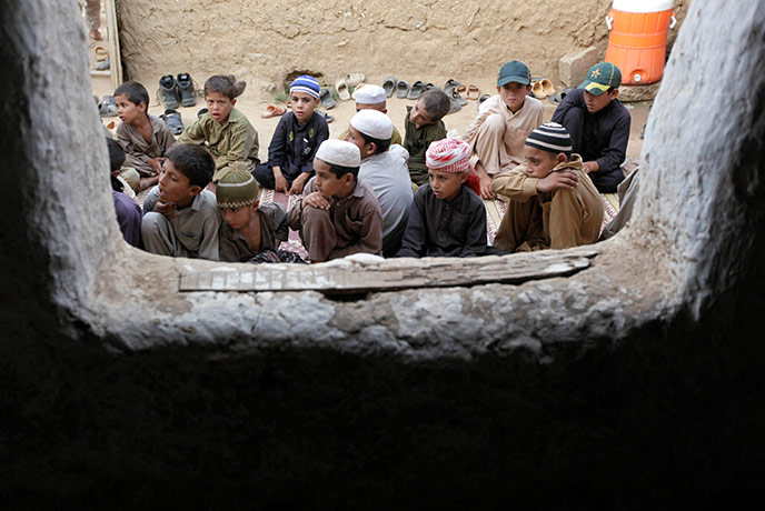 24 hours in pictures:  Afghan boys are seen through the window