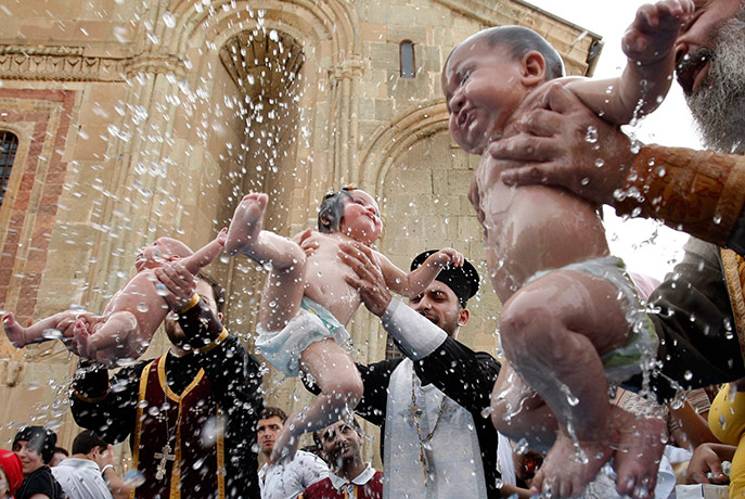 24 hours in pictures: Children are baptized during a mass baptism ceremony, Georgia
