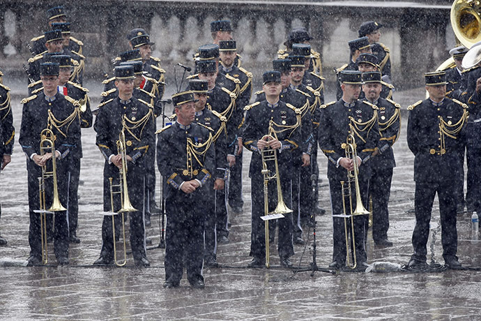 Bastille day: A French military band stands in heavy rain during the Bastille Day parade