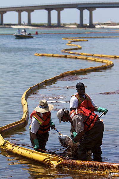 Deepwater Horizon: BP oil spill: Workers Clean Up Oil-Soaked Boom