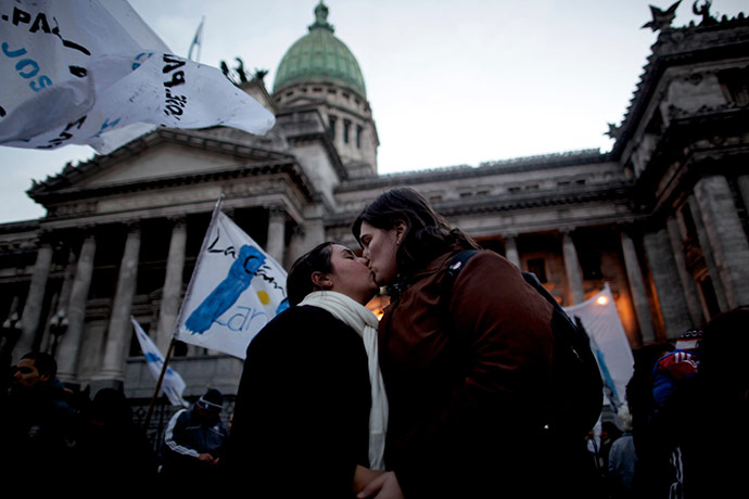 24 hours in pictures: Buenos Aires, Argentina: A gay couple kisses outside congress