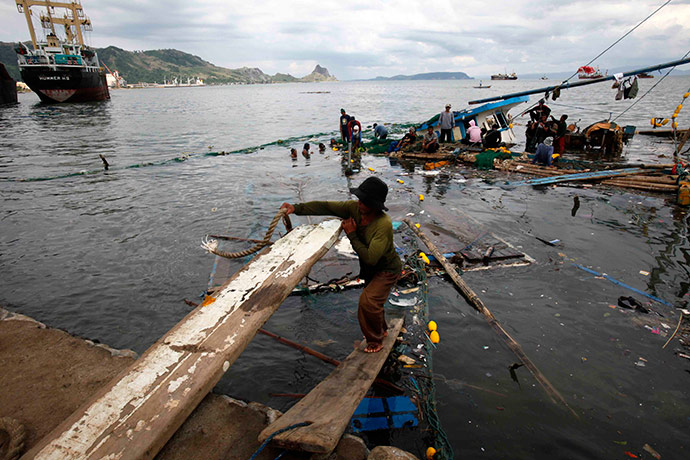 Typhoon Conson: A fisherman on a sunken boat at Mariveles township after Typhoon Conson