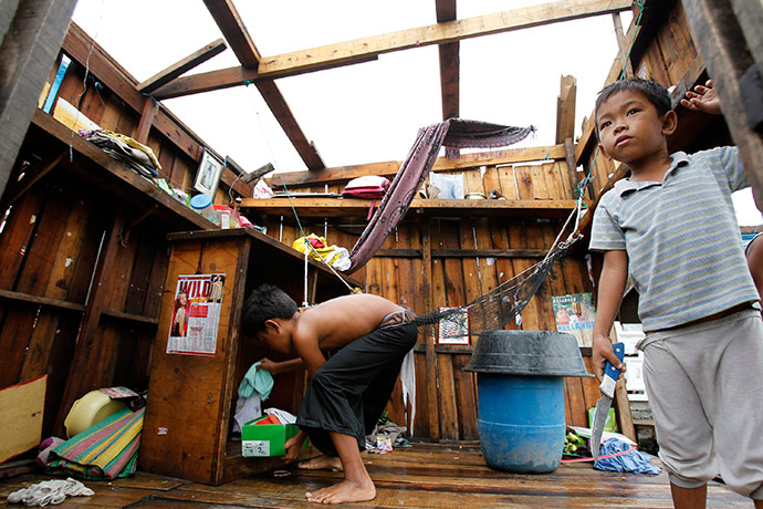 Typhoon Conson: Residents retrieve their clothes from their destroyed house in Las Pinas