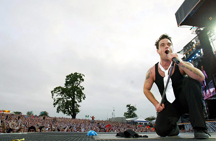 Take That: Singer Robbie Williams performs at Knebworth Park in 2003 