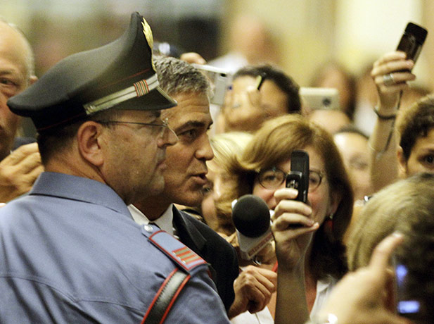 24 hours in pictures: Milan, Italy: George Clooney arrives at a Milan court to testify in a fraud trial