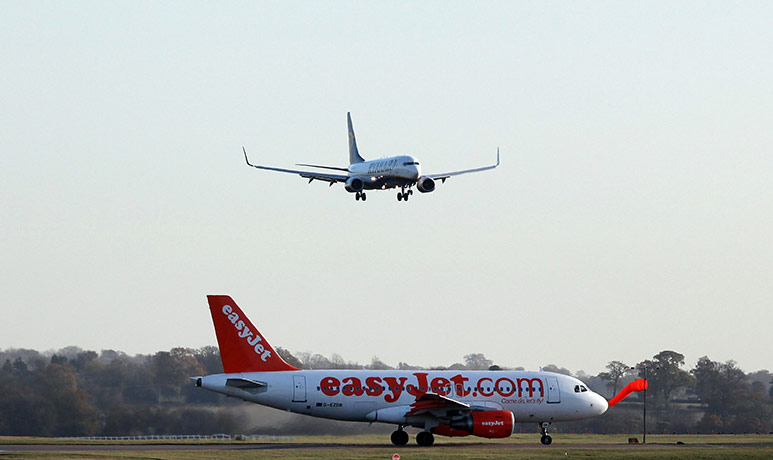 Week in Business: An EasyJet aircraft sits on the runway under a Ryanair plane at Luton
