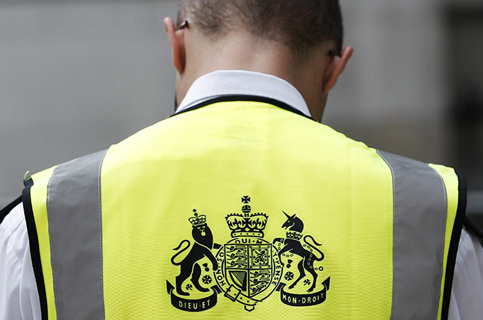 Week in Business: A government department employee wears a high-visibility jacket