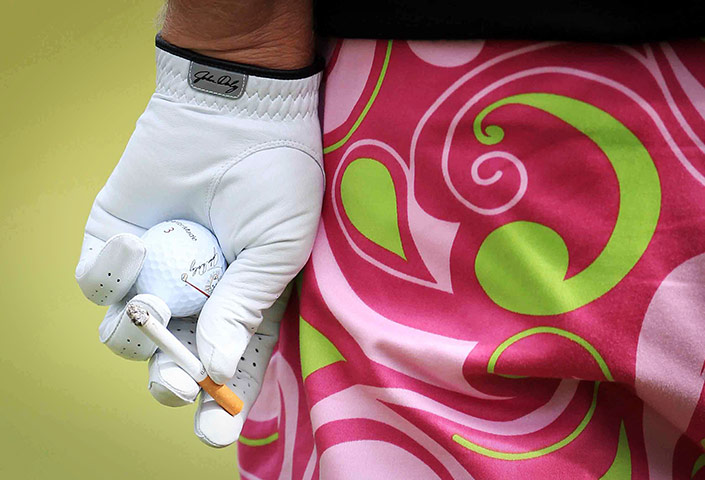 24 Hours in Pictures: John Daly smokes a cigarette during the second round of the Open Golf